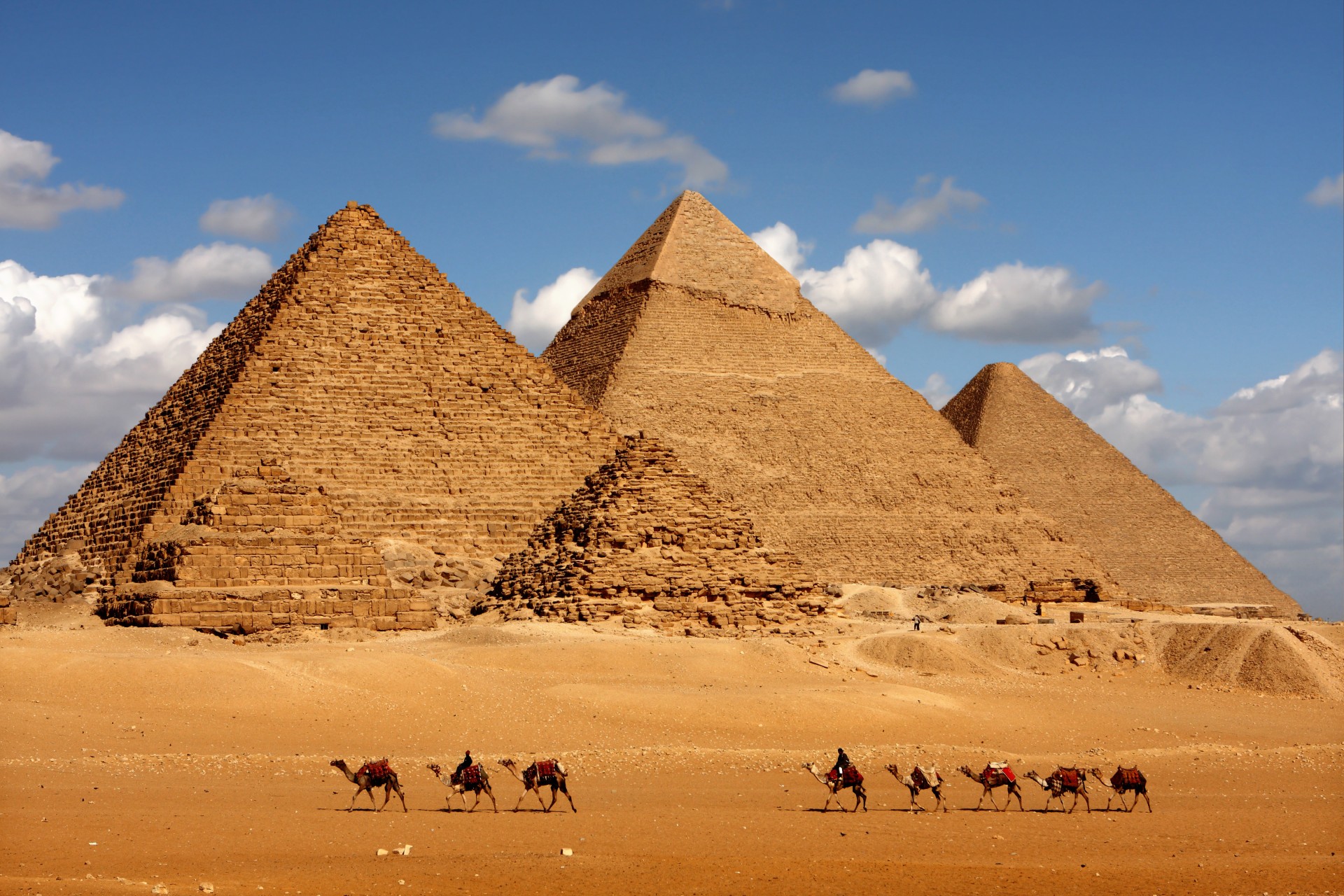 The pyramids of Giza in Cairo, Egypt with a camel caravan panoramic scenic view