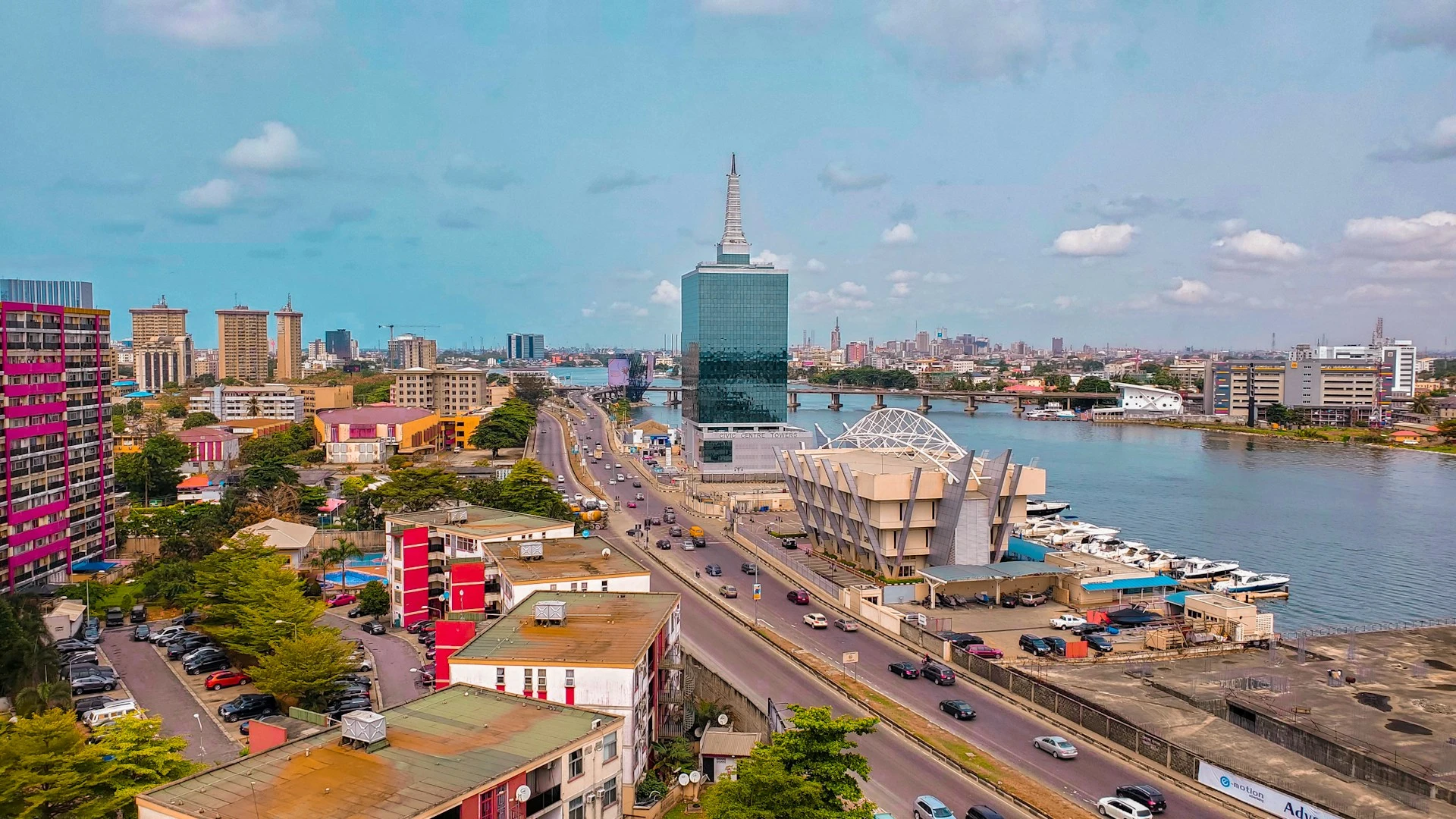 An aerial view of the Lagos skyline, with a prominent skyscraper