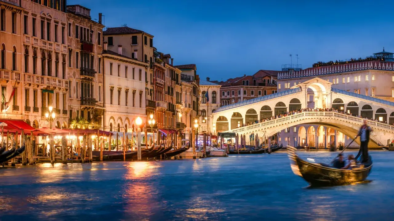 Romantic gondola ride near Rialto Bridge in Venice, Italy