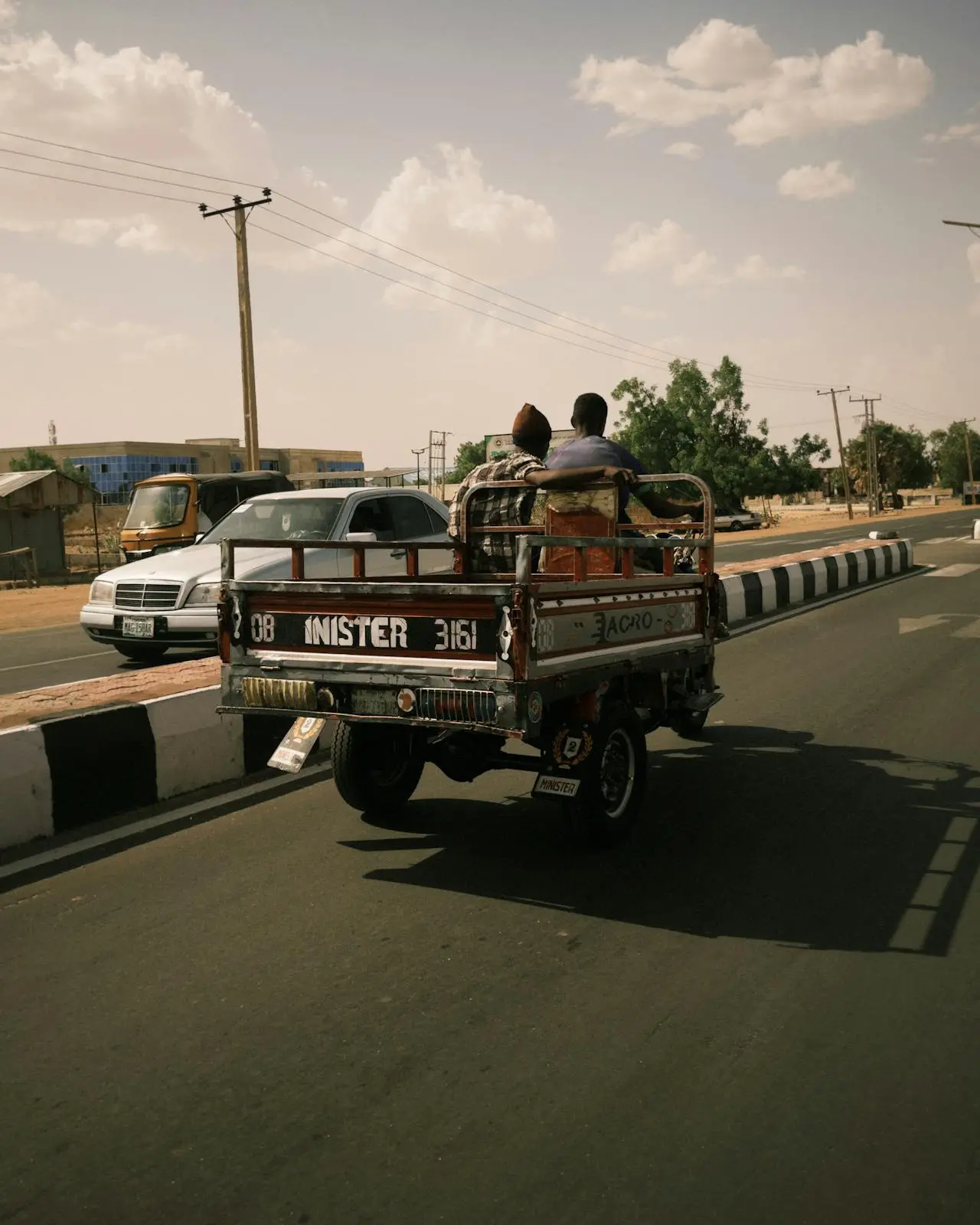 Rural road scene in Nigeria, showing a small truck