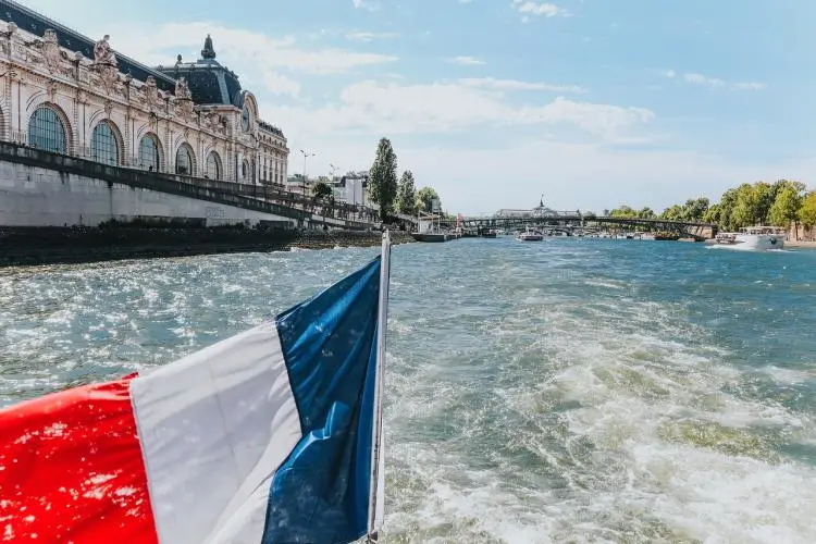 Seine River in Paris, with a French flag