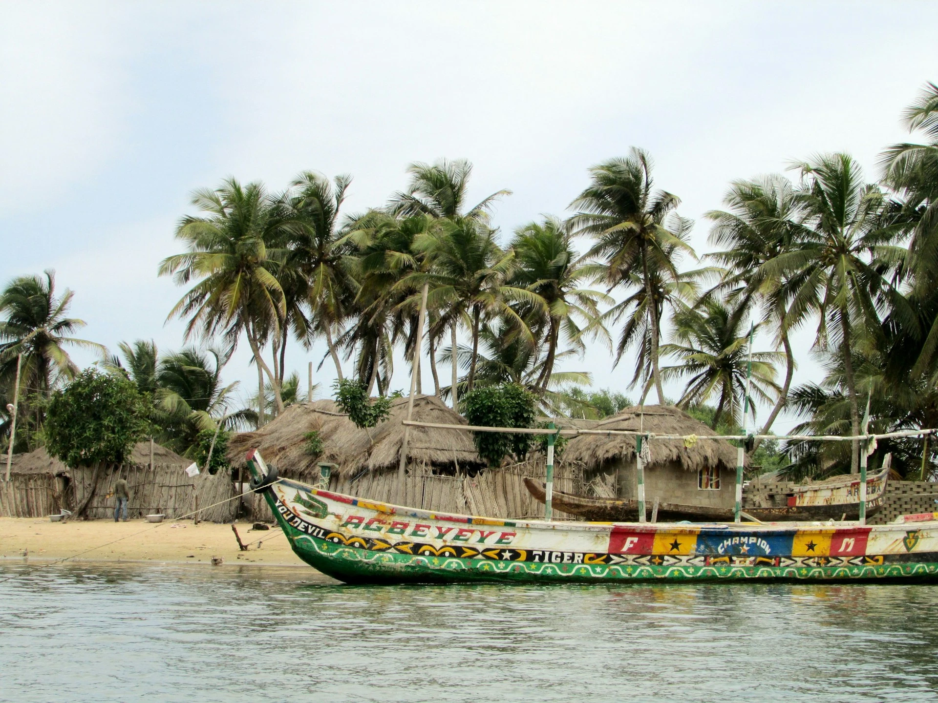 Agbeyeye canoe on a beach in Ghana featured