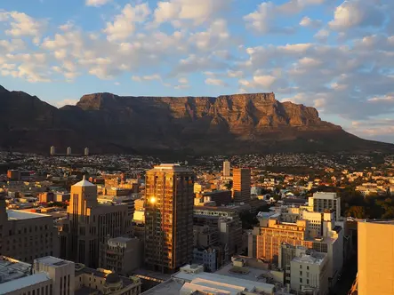 Cape Town South Africa with the iconic flat-topped Table Mountain behind the city and the Atlantic Ocean in the foreground