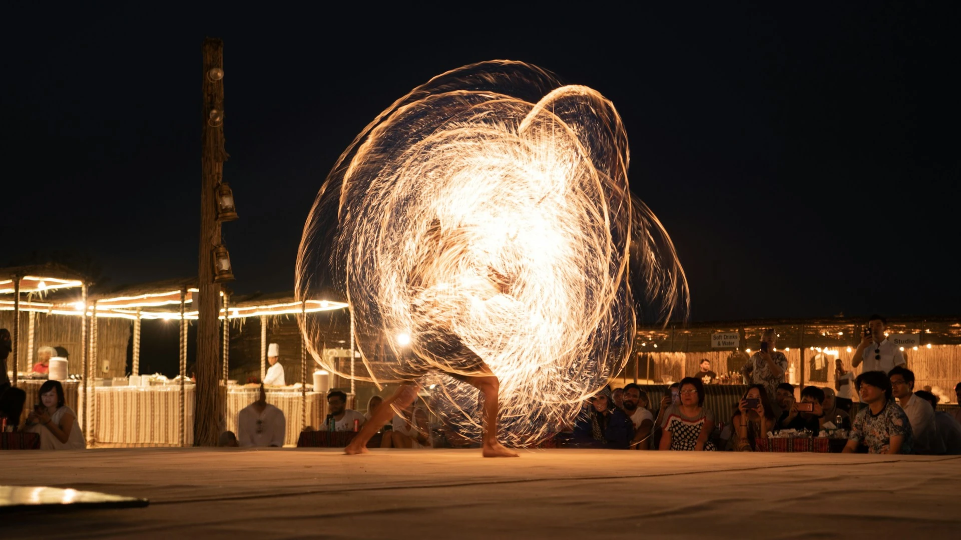 Fire show performer creating a spiral of light