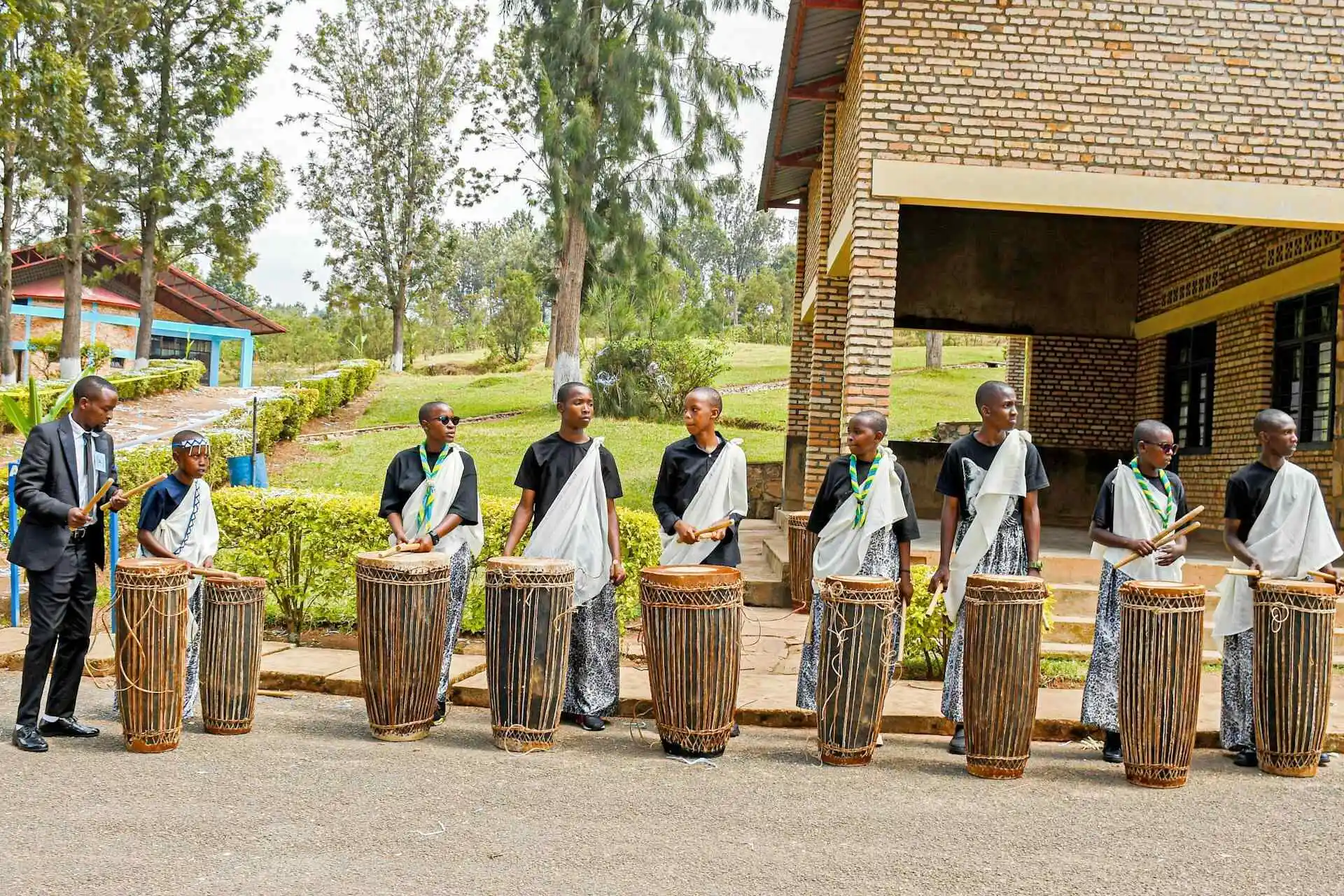 Five people playing traditional drums in rwanda