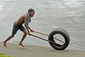 Ghanaian Boy Playing with a Tire for a destination guide
