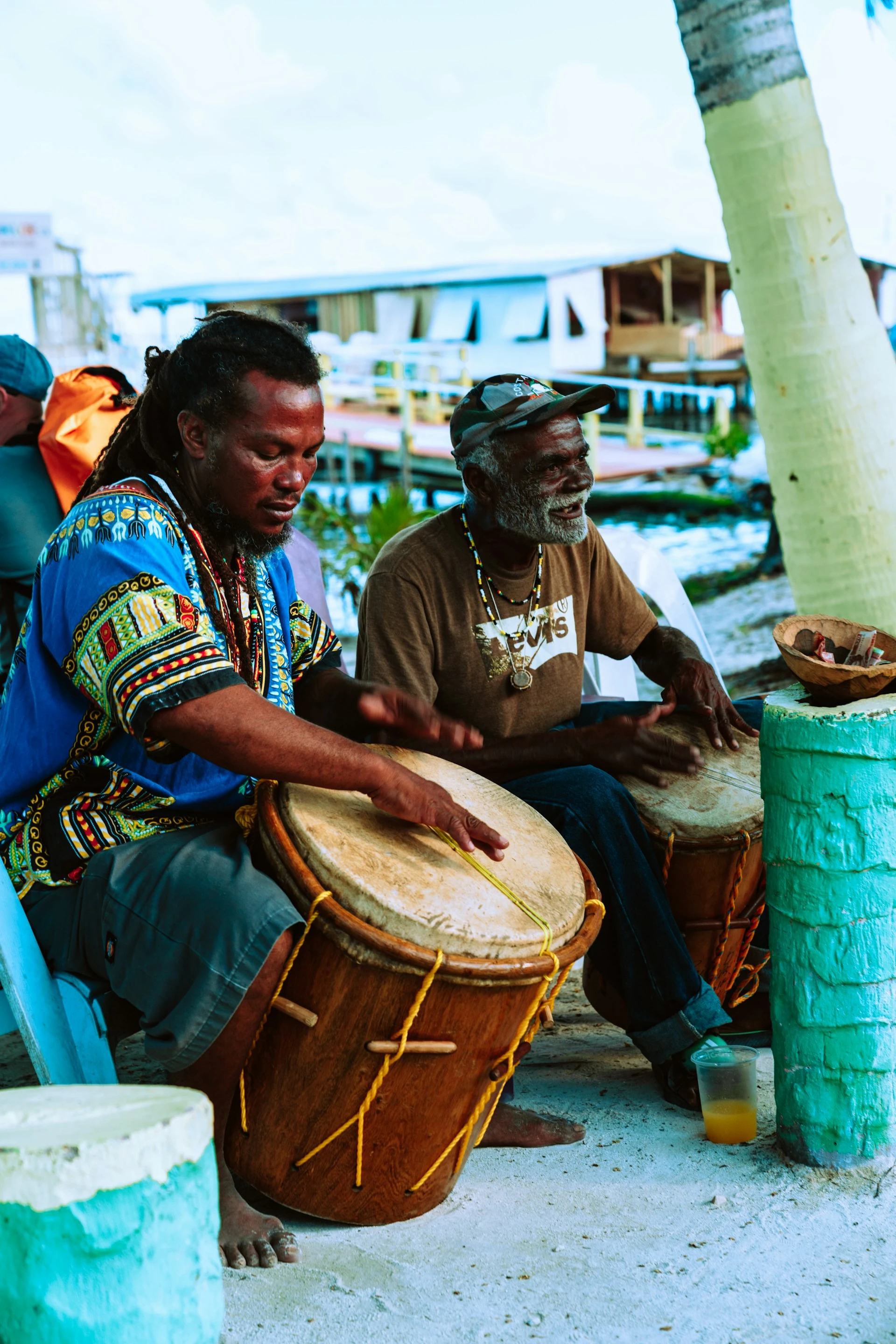 Two men playing Garifuna drums