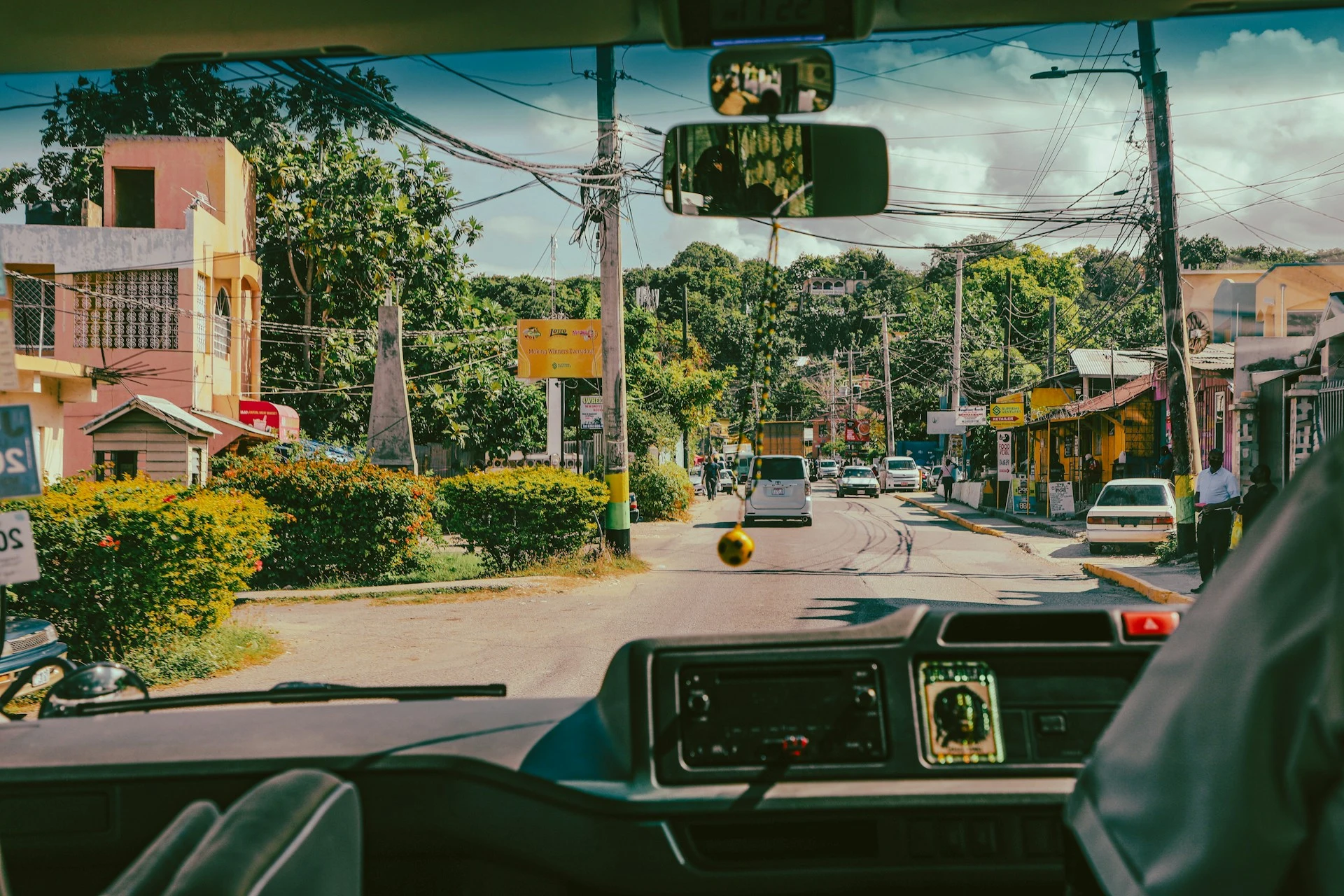 Vehicle traveling down a street in Jamaica for a destination guide