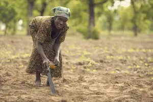 Woman farming in a field for sports travel content
