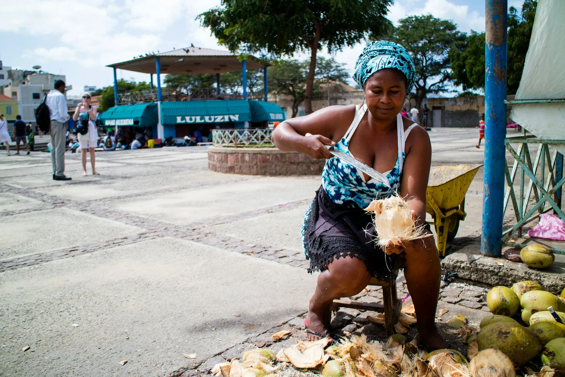 A woman preparing coconuts