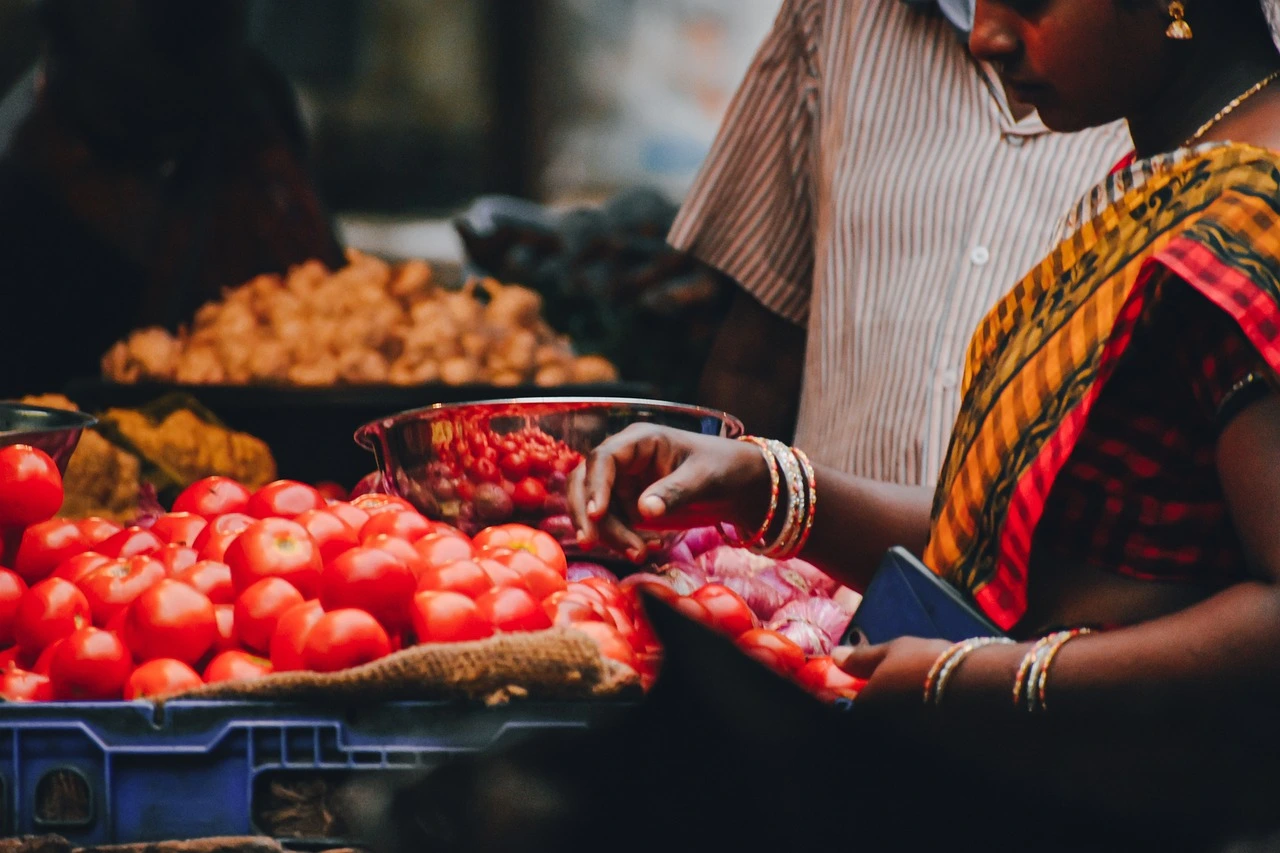 Woman Selling Tomatoes at Makola Market in Ghana during a cultural journey