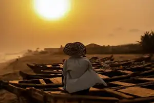 A woman sitting on a boat against the sunset for a destination guide
