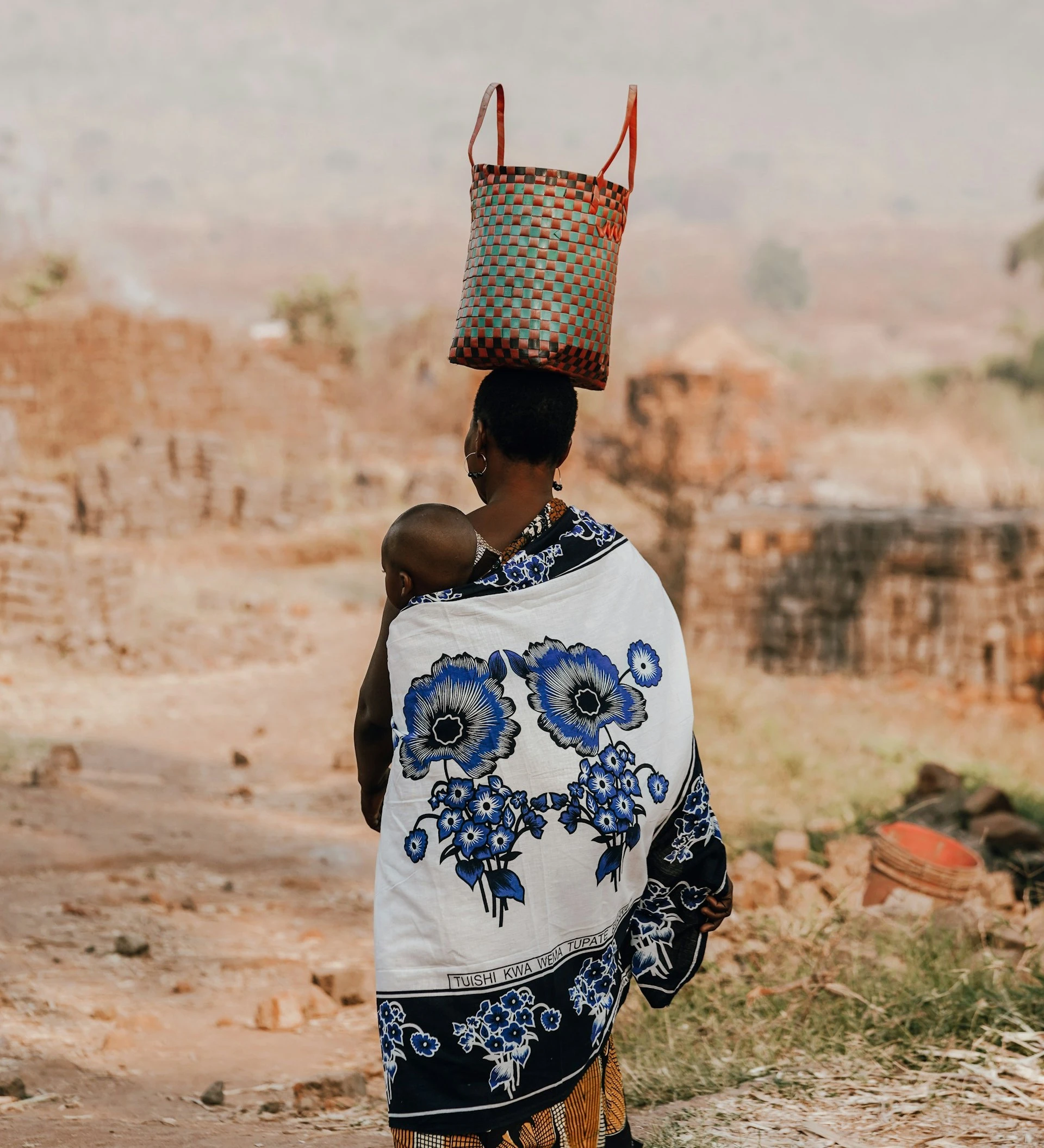 Woman in Tanzania carrying a basket on her head featured