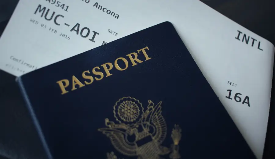 US passport and international boarding pass for flight MUC-AOI; seat 16A; supporting government travel-support document ma...
