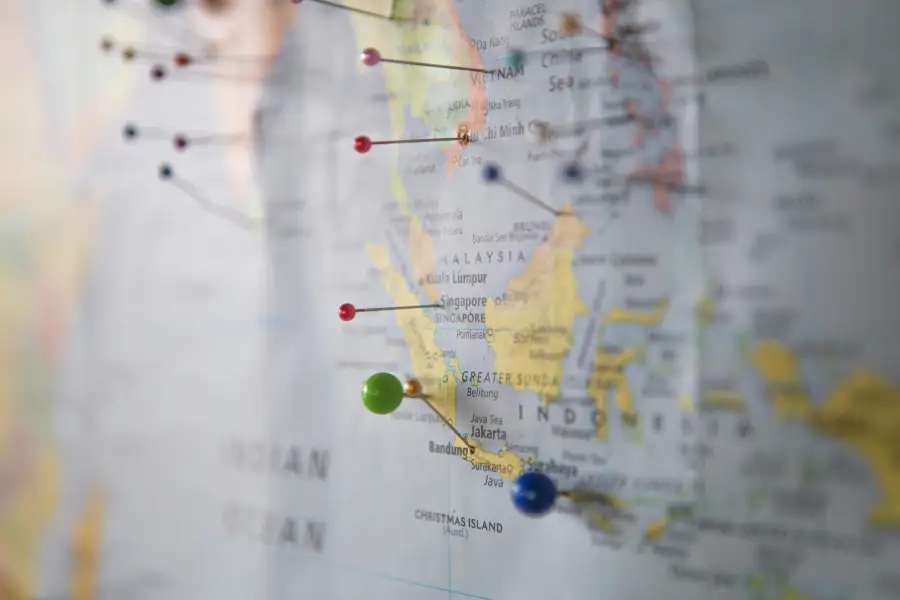 Map of Southeast Asia with colorful pushpins marking travel support destinations including Vietnam; Malaysia; Singapore; a...