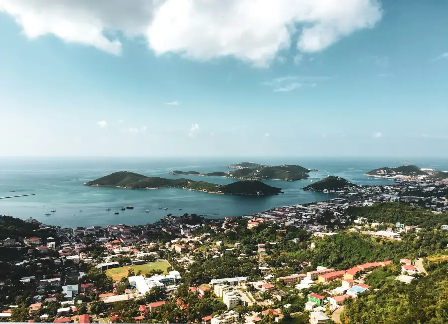 Aerial view of Charlotte Amalie harbor on St. Thomas with green hills and turquoise Caribbean water.