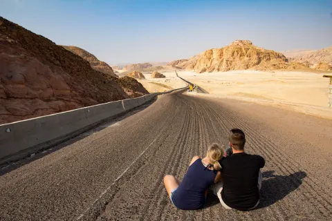 Couple Sitting on Road for a destination guide