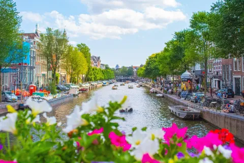 A picturesque view of a canal in Amsterdam for the Netherlands page on LABUSA Travel.