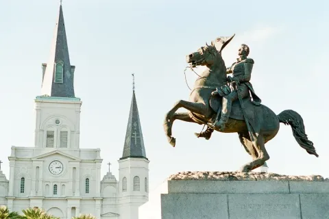 The Andrew Jackson equestrian statue in Jackson Square with the historic St. Louis Cathedral behind it in the New Orleans French Quarter
