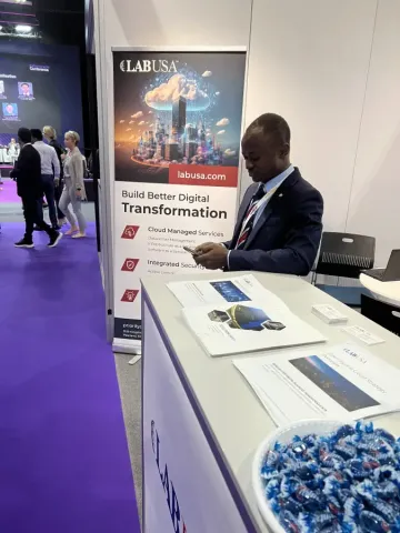 LABUSA representative at Intersec conference booth displaying digital transformation brochures and cloud managed services...