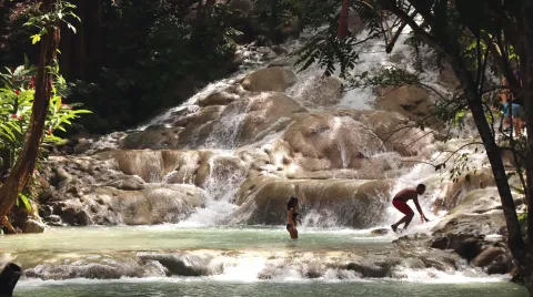 Visitors climbing the terraced limestone cascades of Dunn's River Falls at Ocho Rios.