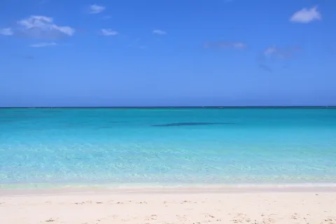 Clear turquoise shallows over pale sand at Grace Bay on Providenciales.