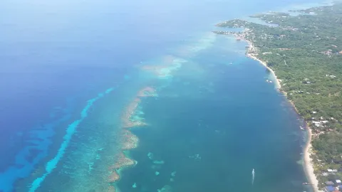 Aerial view of Roatan's north west shore, the fringing reef showing turquoise against deep blue water.