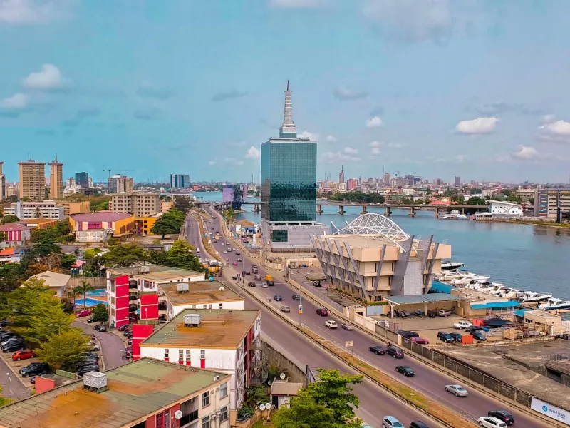 An aerial view of the Lagos skyline, with a prominent skyscraper