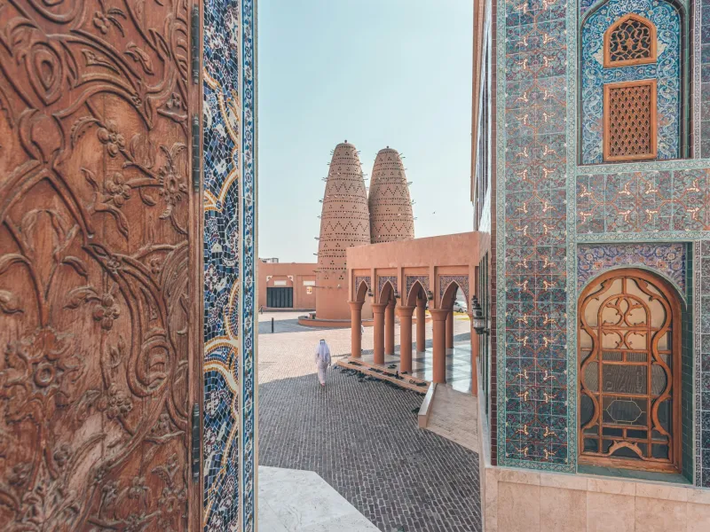 Pigeon towers and an ornately tiled doorway at Katara Cultural Village in Doha.