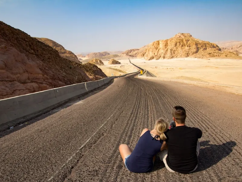 Couple Sitting on Road for a destination guide