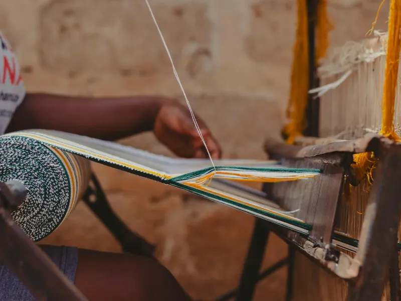 Traditional Kente weaving in Kumasi, Ghana, representing Ashanti culture and heritage on Ghana cultural tours