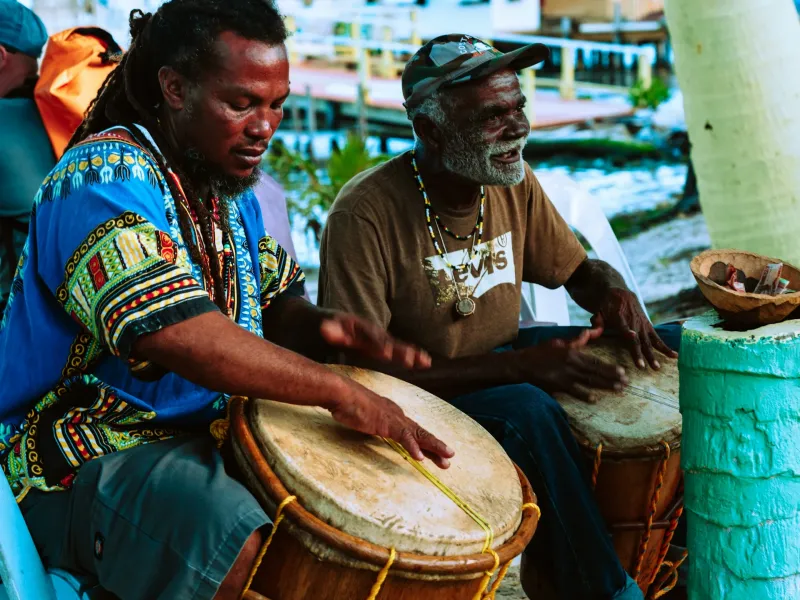 Two men playing Garifuna drums