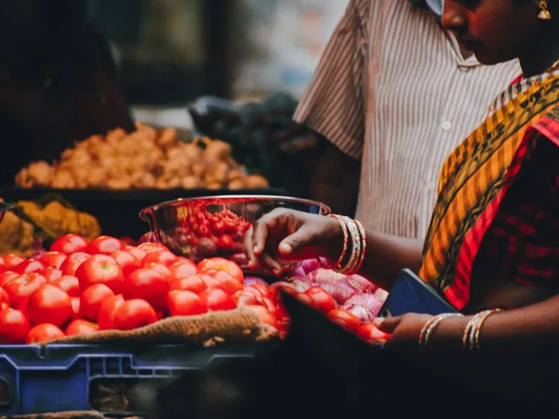 Woman Selling Tomatoes at Makola Market in Ghana during a cultural journey