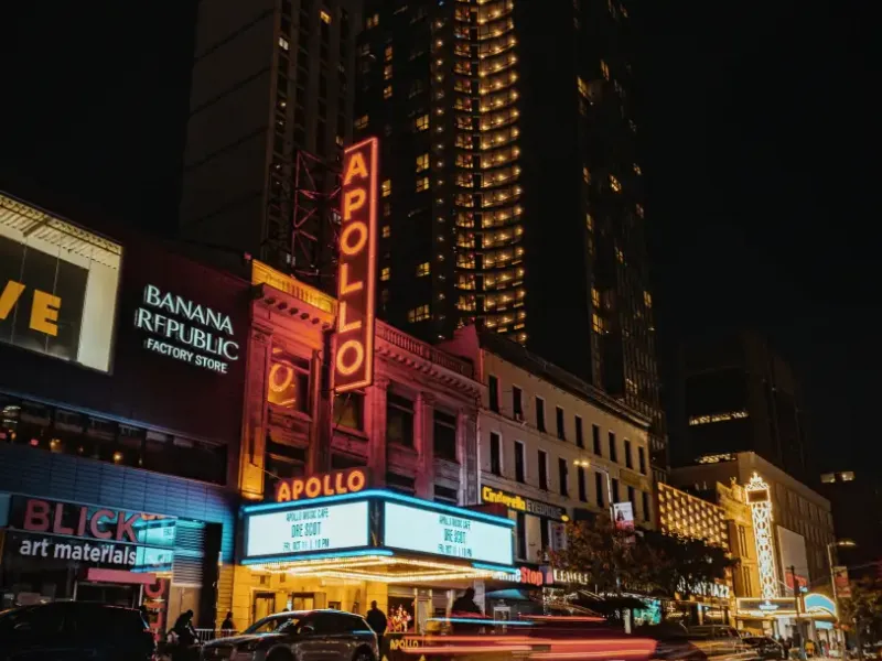 Apollo Theater marquee lit up at night in Harlem New York New York with light trails and neon signage on 125th Street