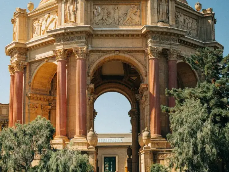 Palace of Fine Arts rotunda with Roman columns and dome reflected in lagoon; San Francisco; CA on a clear sunny day.