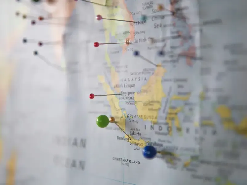 Map of Southeast Asia with colorful pushpins marking travel support destinations including Vietnam; Malaysia; Singapore; a