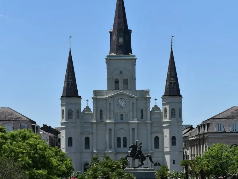 The white spires of St. Louis Cathedral rising above Jackson Square in the New Orleans French Quarter