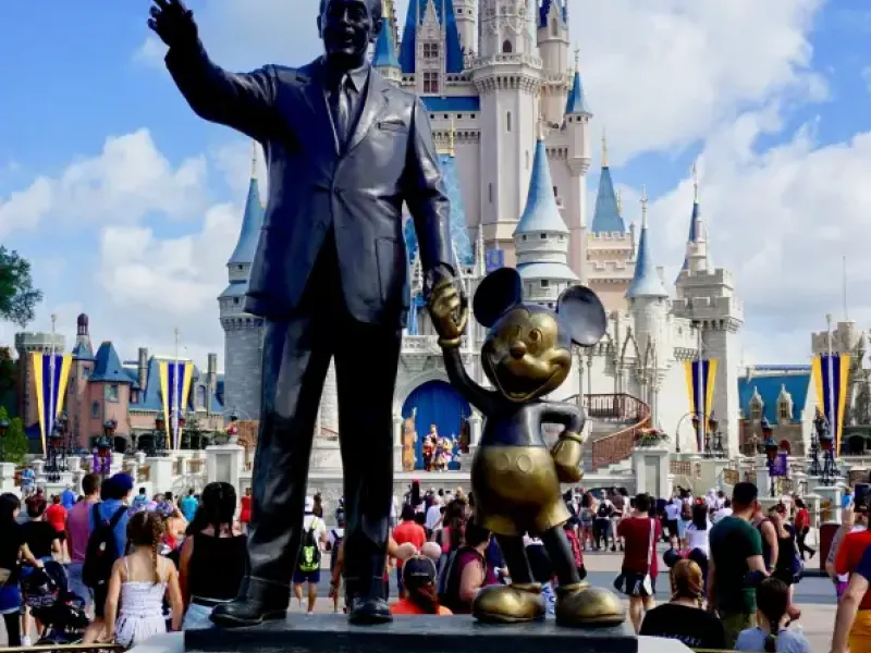 Partners statue of Walt Disney and Mickey Mouse with Cinderella Castle behind it at Magic Kingdom in Orlando; FL.