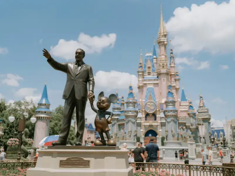 Partners statue of Walt Disney and Mickey Mouse with Cinderella Castle at Magic Kingdom; Orlando FL.