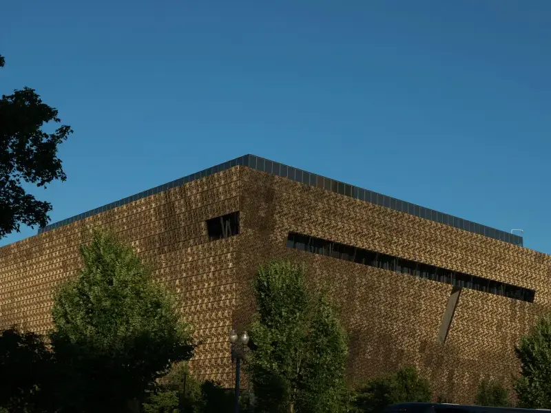 The bronze latticed exterior of the National Museum of African American History and Culture in Washington; DC; under a cle