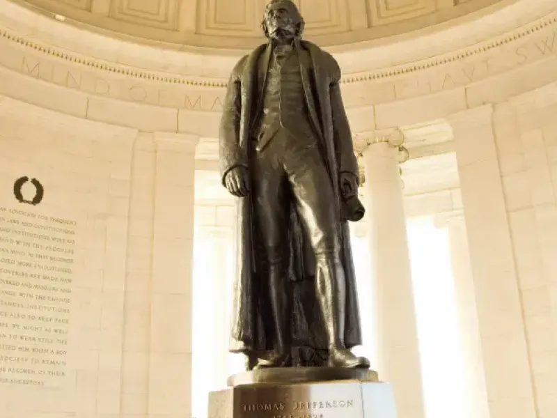 Bronze statue of Thomas Jefferson inside the domed Jefferson Memorial rotunda in Washington; DC; with inscribed quotes on