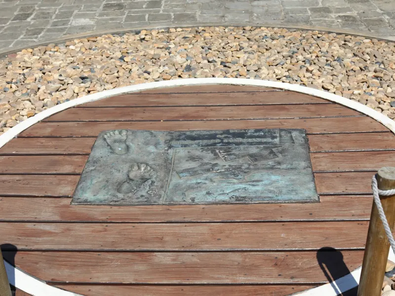 A commemorative stone set into a circular timber deck in the grounds of Aapravasi Ghat, Port Louis.