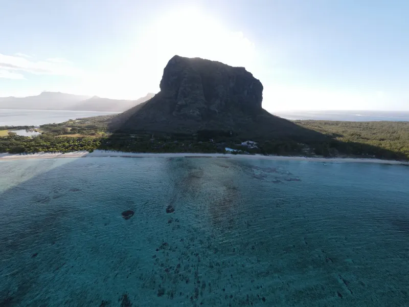 The sheer basalt block of Le Morne Brabant rising from the lagoon in early morning light, southwest Mauritius.