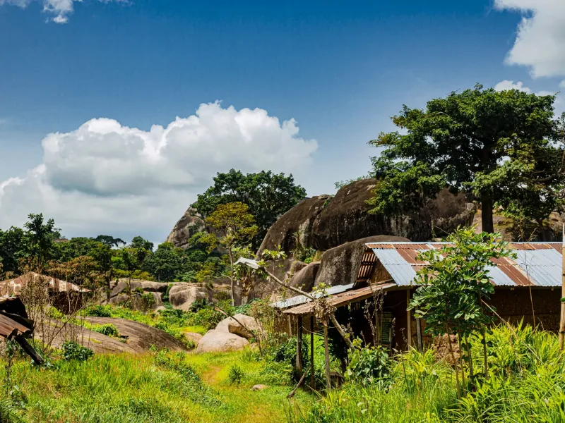 Granite domes and boulders rising above trees and tin-roofed buildings at Idanre in Ondo State, Nigeria.