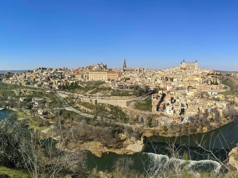 The hill town of Toledo, Spain, inside a bend of the Tagus, its cathedral spire and Alcazar rising above tiled roofs.