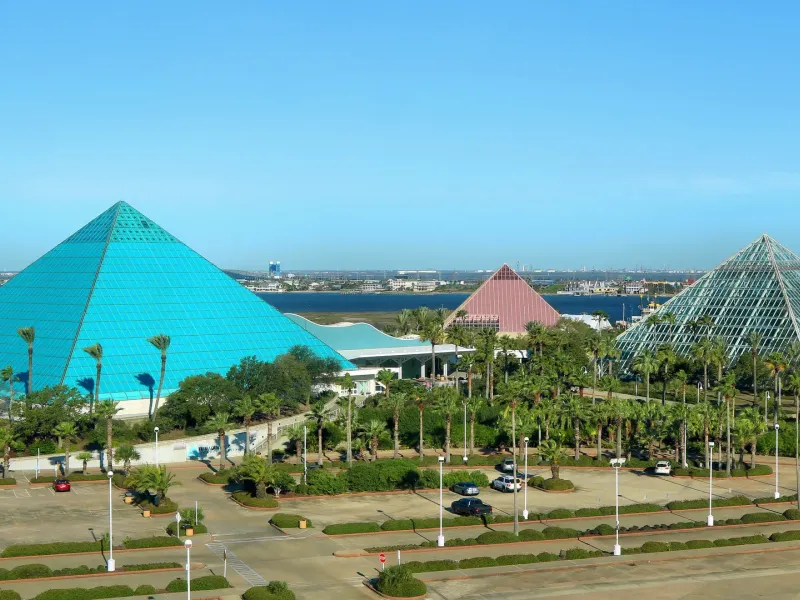 The blue aquarium pyramid, pink discovery pyramid and glass rainforest pyramid of Moody Gardens in Galveston.