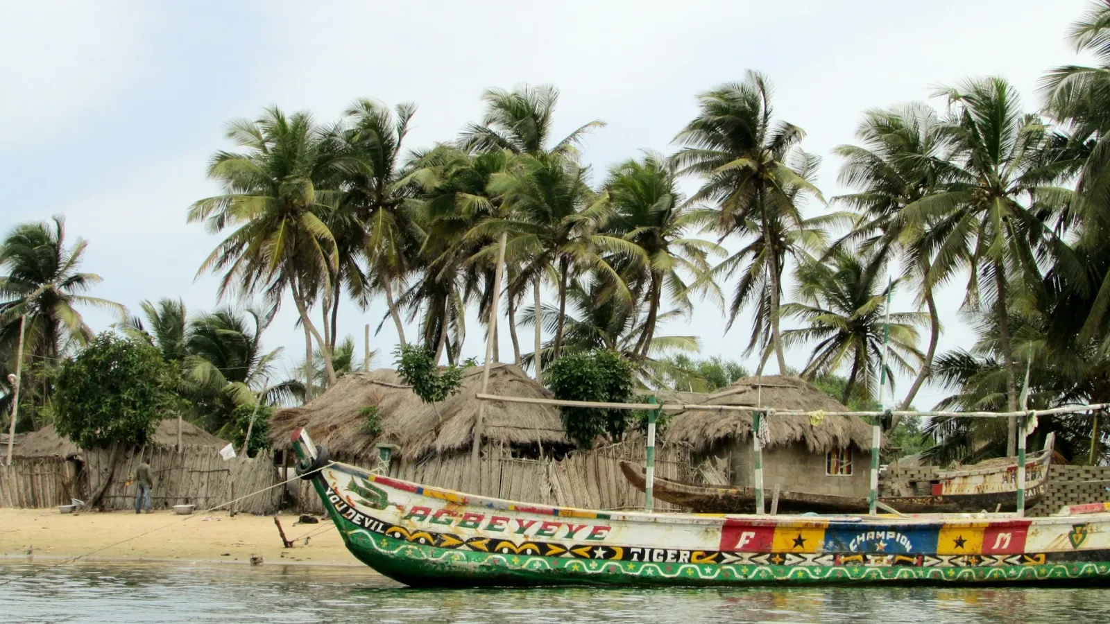 Agbeyeye canoe on a beach in Ghana featured