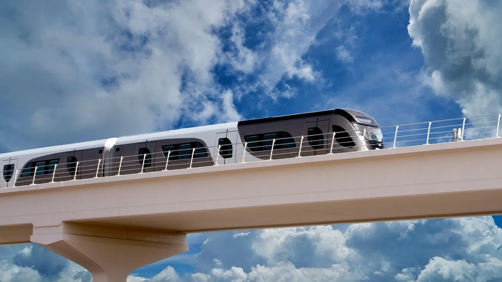 A Doha Metro train crossing an elevated track under a blue sky.