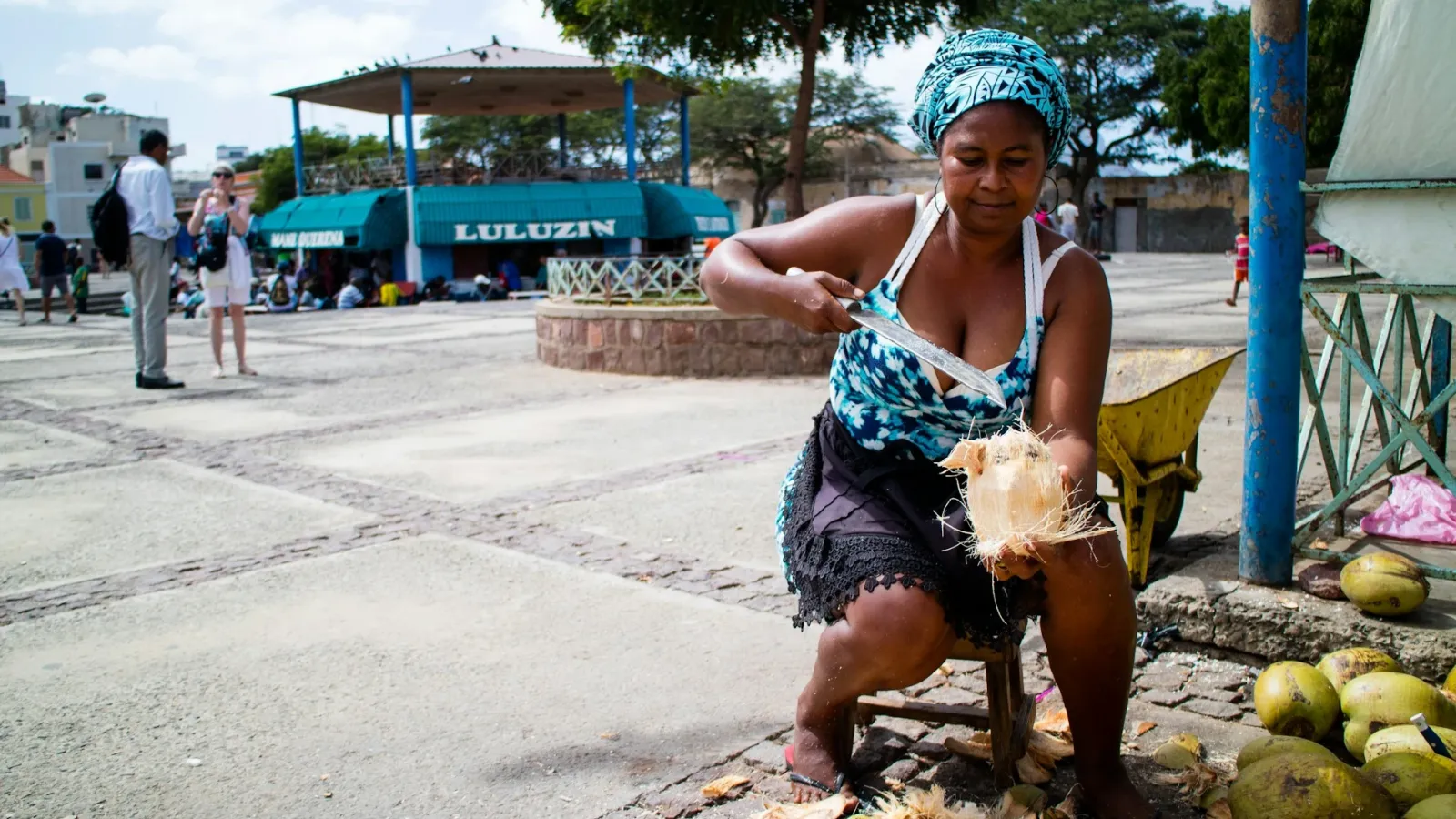 A woman preparing coconuts