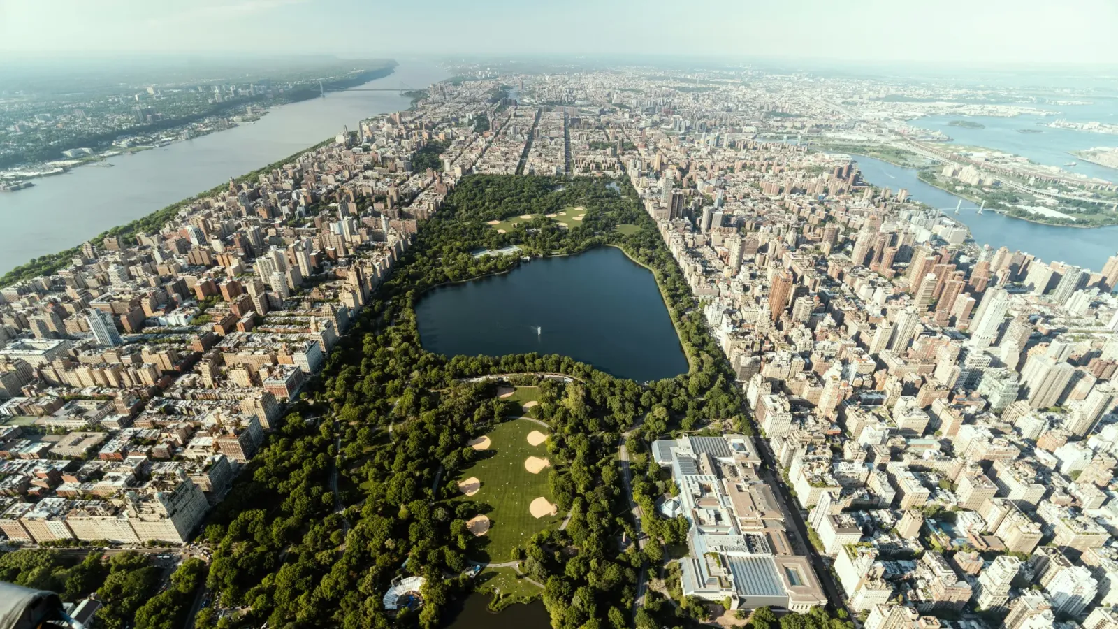Aerial view of Central Park in New York New York with the reservoir lake surrounded by Manhattan's skyline and the Hudson River beyond